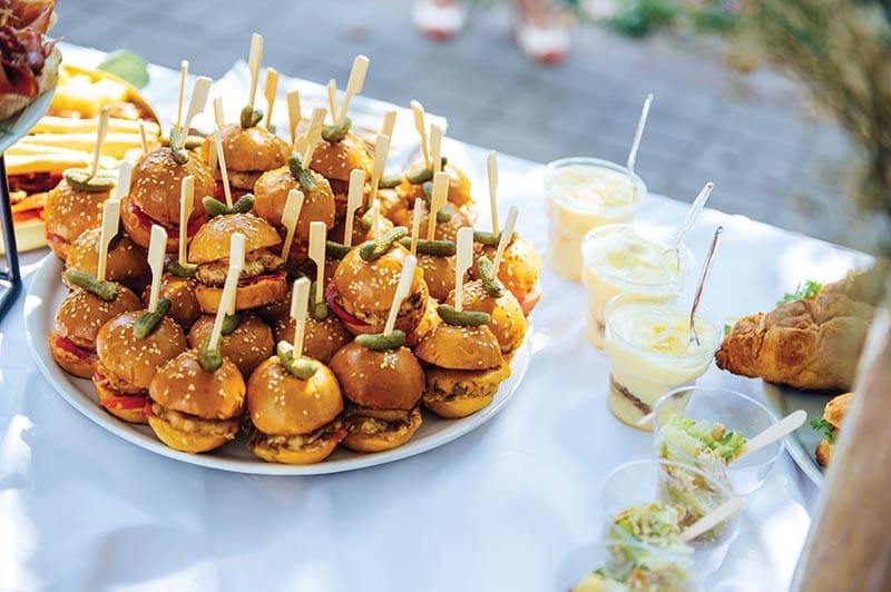 Wedding cake table background. Sweet and delicious restaurant desserts. Tasty food on buffet party. Banquet snacks texture. Catering table background.